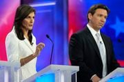 Republican presidential candidate former U.N. Ambassador Nikki Haley speaks as Florida Gov. Ron DeSantis listens during a Republican presidential primary debate hosted by NBC News, Wednesday, Nov. 8, 2023, at the Adrienne Arsht Center for the Performing Arts of Miami-Dade County in Miami.