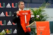 Miami new football coach, Mario Cristobal, holds up a jersey after being introduced at a news conference Tuesday, Dec. 7, 2021, in Coral Gables, Fla. Cristobal is returning to his alma mater, where he won two championships as a player. (AP Photo/Lynne Sladky) AP