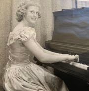 Young Dorothy Fahlman playing the piano.