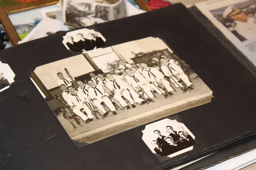 A scrapbook photo of sailors posing in uniform