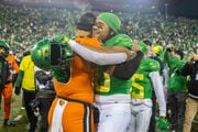 Oregon linebacker Matayo Uiagalelei (right) embraces older brother and Oregon State quarterback DJ Uiagalelei (left) following the No. 6 Ducks’ 31-7 win over the No. 16 Beavers in a college football game at Autzen Stadium in Eugene, Oregon on Saturday, Nov. 24, 2023. 