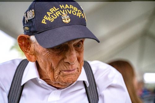 A closeup of Harry Chandler, wearing a Pearl Harbor Survivor ballcap