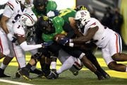 Oregon quarterback Anthony Brown, center, is dropped for a safety as the No. 3 Ducks face the Arizona Wildcats in a college football game at Autzen Stadium in Eugene, Oregon on Saturday, Sept. 25, 2021.
