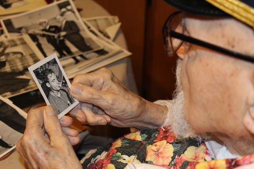 Ike Schab looking at a black and white photo