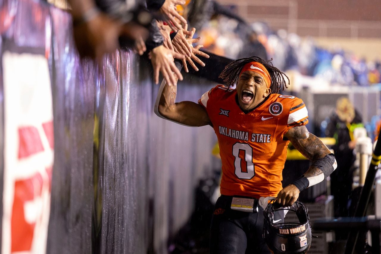 Oklahoma State running back Ollie Gordon II (0) celebrates with fans after the team's NCAA college football game against BYU on Saturday, Nov. 25, 2023, in Stillwater, Okla. (AP Photo/Mitch Alcala)